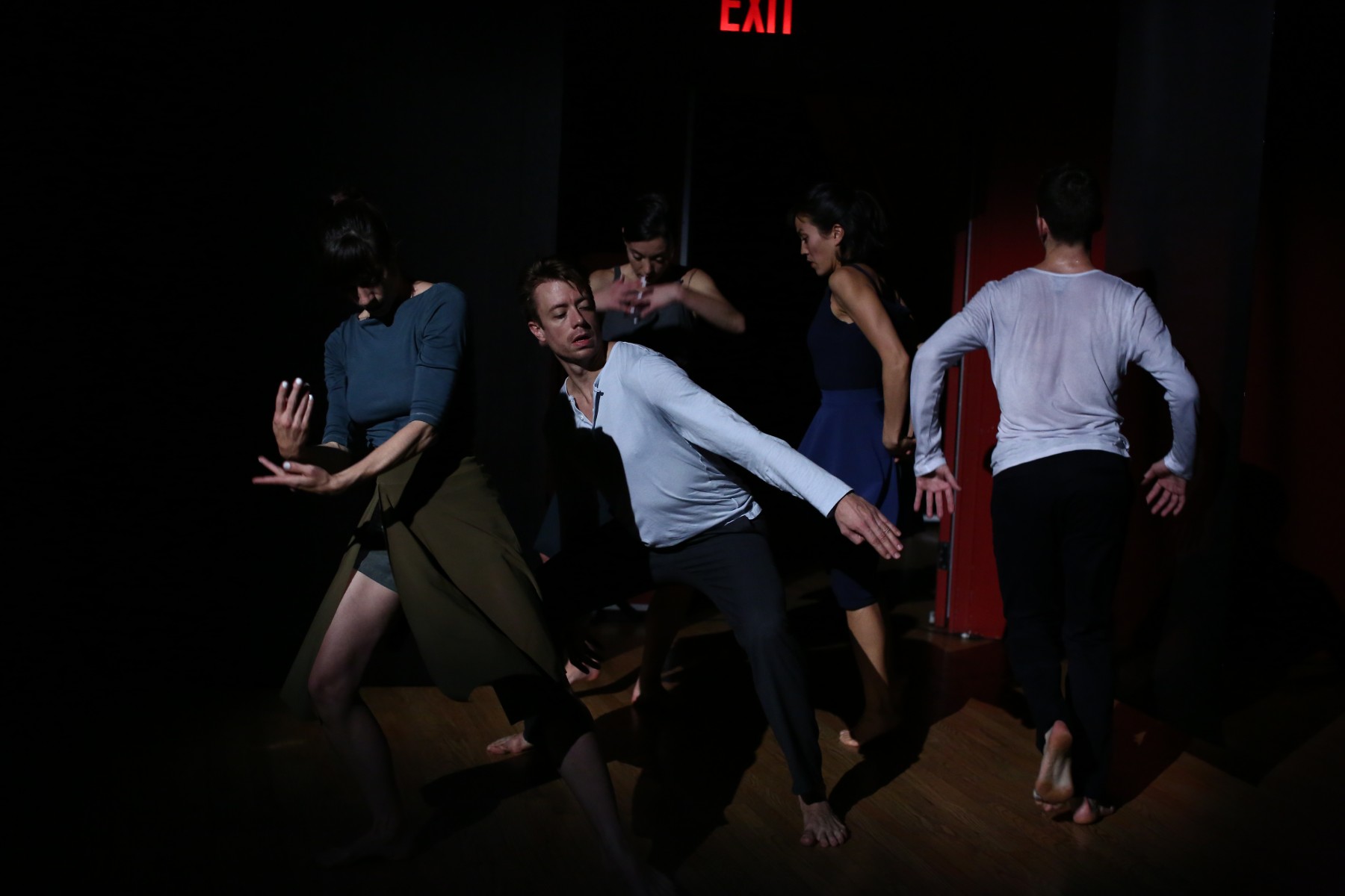 Sally Silver's cast dances in a tight clump in the shadows